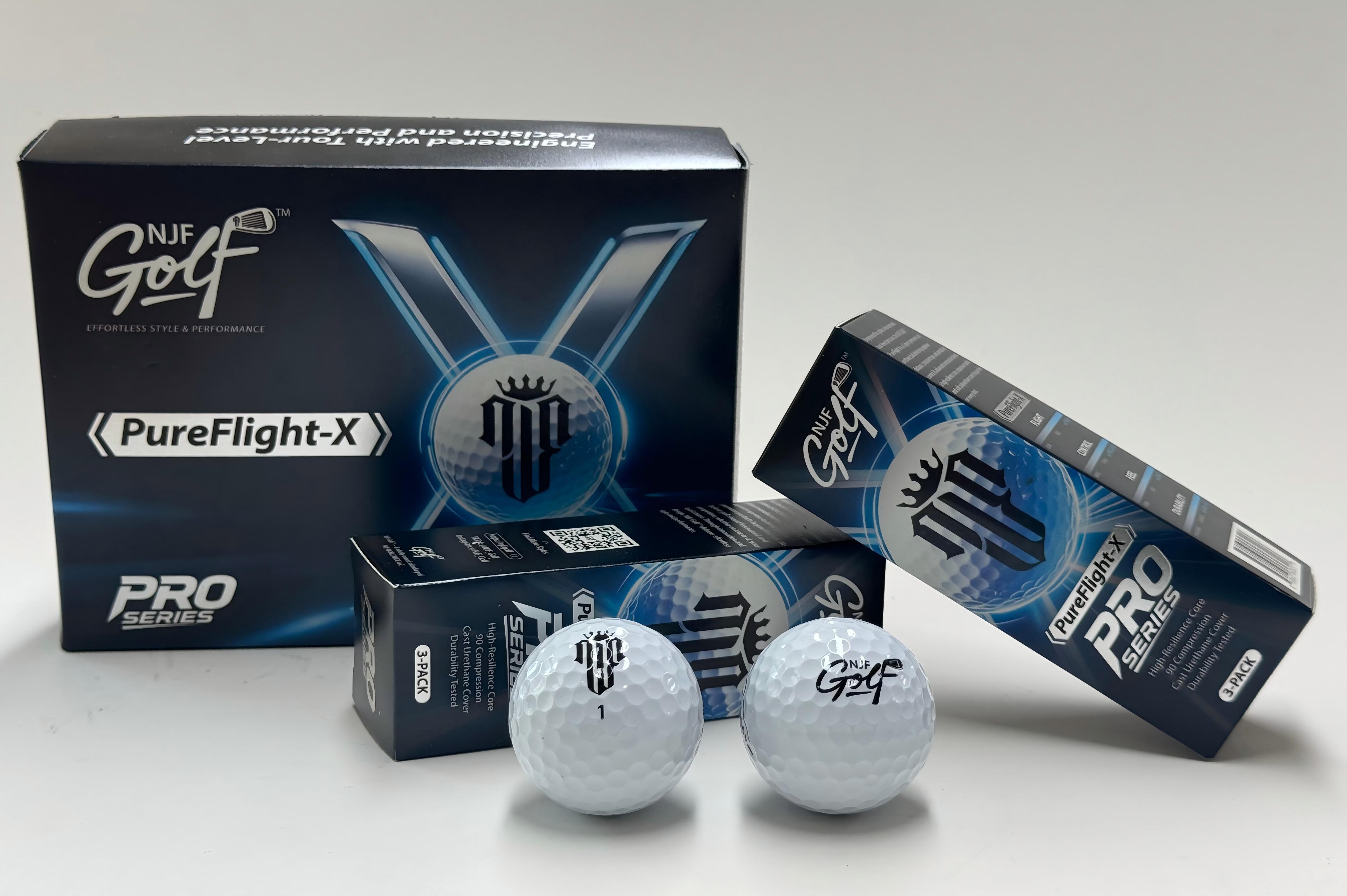 NJF PureFlight-X factory-finished product: completed 3-piece polyurethane golf balls with retail packaging, photographed at MetaSeal factory on 2026-06-22